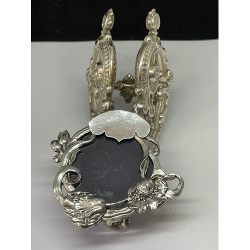 789 - AN UNUSUAL WHITE METAL PHOTOGRAPH FRAME ON A SILVER STAND