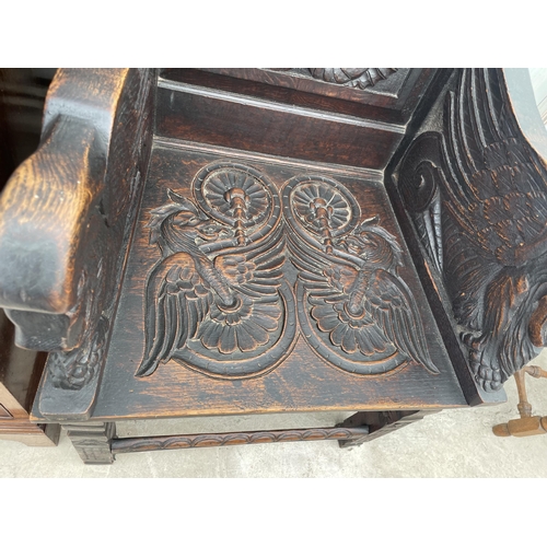 2203 - AN 18TH CENETURY OAK WAINSCOT CHAIR WITH CARVED BACK PANEL AND SEAT WITH MYTHICAL DRAGON LIKE ARM TE... 