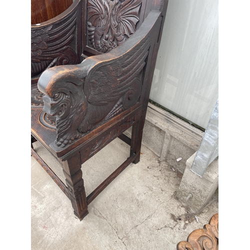 2203 - AN 18TH CENETURY OAK WAINSCOT CHAIR WITH CARVED BACK PANEL AND SEAT WITH MYTHICAL DRAGON LIKE ARM TE... 