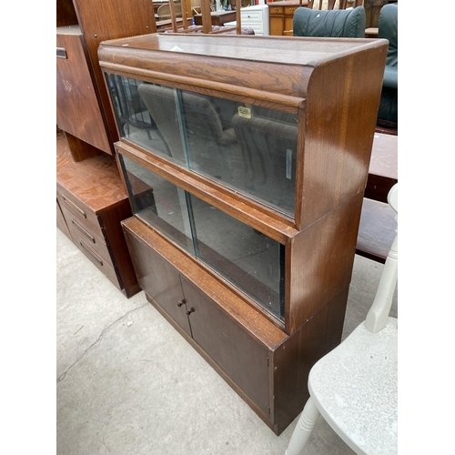 2359 - A MID 20TH CENETURY 'WILTON' OAK BOOKCASE WITH FOUR GLASS SLIDING DOORS AND CUPBOARDS TO THE BASE, 3... 