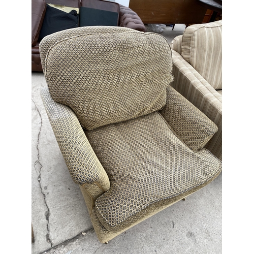 2428 - A MODERN EASY CHAIR ON TURNED FRONT LEGS WITH BRASS CASTERS