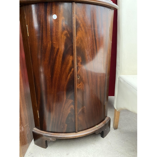 2473 - A MAHOGANY BOW FRONT CORNER CABINET