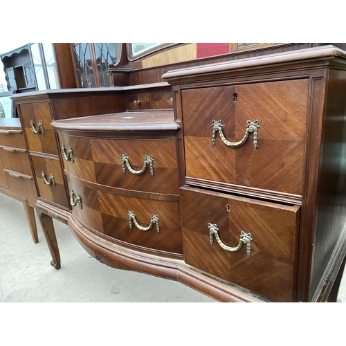 2502 - AN EDWARDIAN MAHOGANY BOW FRONTED DRESSING TABLE ENCLOSING FOUR SHORT, TWO LONG AND THREE JEWELLED D... 