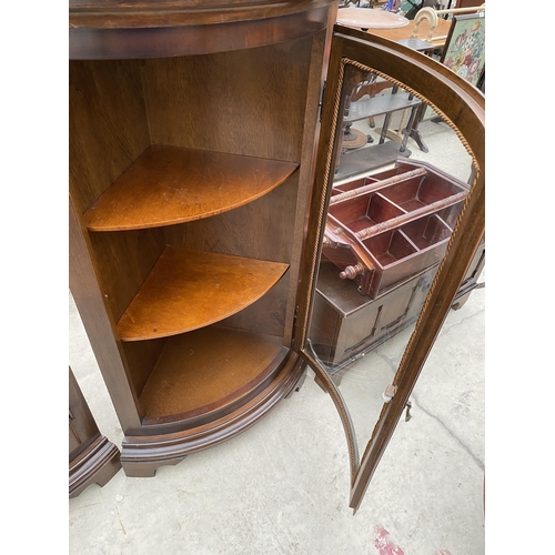 2519 - A PAIR OF MODERN MAHOGANY BOW FRONTED CORNER CABINETS ON BRACKET FEET, 24