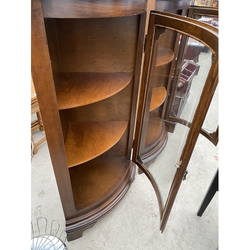 2519 - A PAIR OF MODERN MAHOGANY BOW FRONTED CORNER CABINETS ON BRACKET FEET, 24