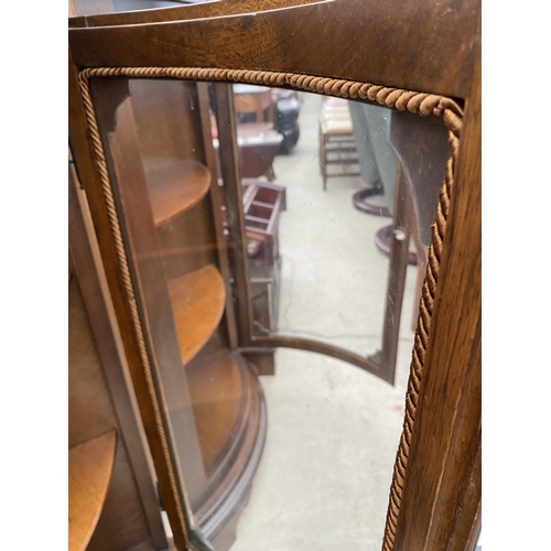 2519 - A PAIR OF MODERN MAHOGANY BOW FRONTED CORNER CABINETS ON BRACKET FEET, 24