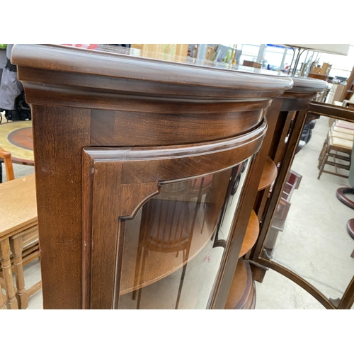 2519 - A PAIR OF MODERN MAHOGANY BOW FRONTED CORNER CABINETS ON BRACKET FEET, 24