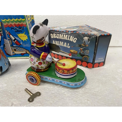 2865 - TWO VINTAGE BOXED TIN PLATE TOYS - A SEAL PLAYING BALL AND A DRUMMING PANDA