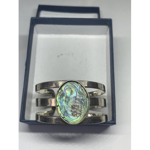 693 - A SILVER BANGLE WITH LARGE PEARLISED STONE IN A PRESENTATION BOX