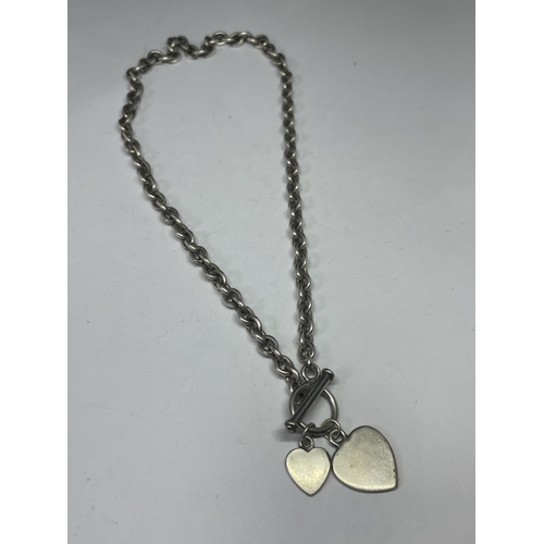 705 - A SILVER T BAR NECKLACE WITH HEART PENDANTS