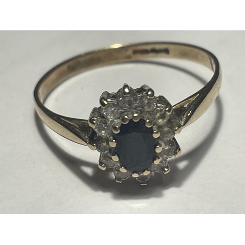 616 - A 9 CARAT GOLD RING WITH A CENTRE SAPPHIRE SURROUNDED BY CUBIC ZIRCONIA STONES SIZE T