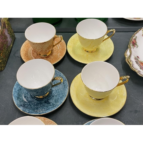 64 - A QUANTITY OF ROYAL ALBERT 'GOSSAMER' CUPS AND SAUCERS IN DIFFERENT COLOURS ( 10 IN TOTAL )