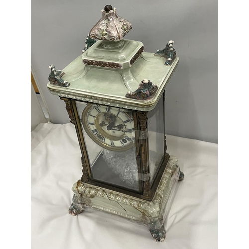 67 - AN ANTIQUE MANTLE CLOCK WITH BEVELLED GLASS CASE WITH GLASS FRAME, PALE CERAMIC FOOTED BASE AND TOP ... 