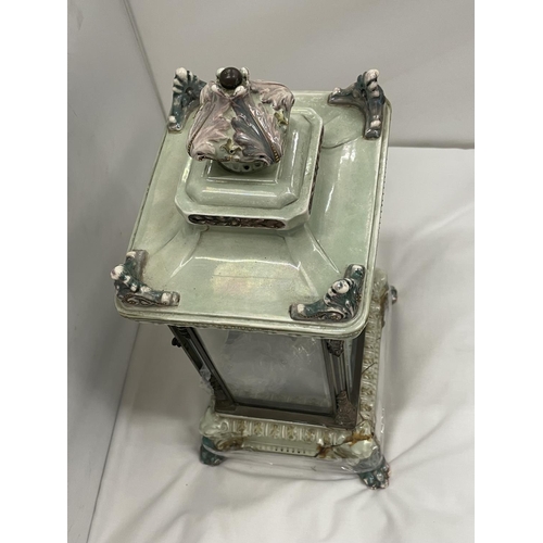 67 - AN ANTIQUE MANTLE CLOCK WITH BEVELLED GLASS CASE WITH GLASS FRAME, PALE CERAMIC FOOTED BASE AND TOP ... 