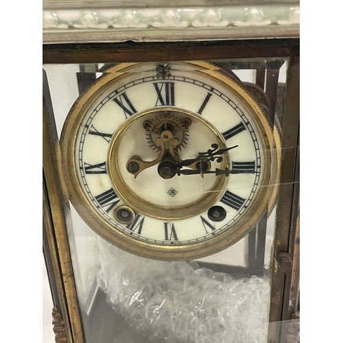 67 - AN ANTIQUE MANTLE CLOCK WITH BEVELLED GLASS CASE WITH GLASS FRAME, PALE CERAMIC FOOTED BASE AND TOP ... 