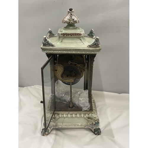 67 - AN ANTIQUE MANTLE CLOCK WITH BEVELLED GLASS CASE WITH GLASS FRAME, PALE CERAMIC FOOTED BASE AND TOP ... 