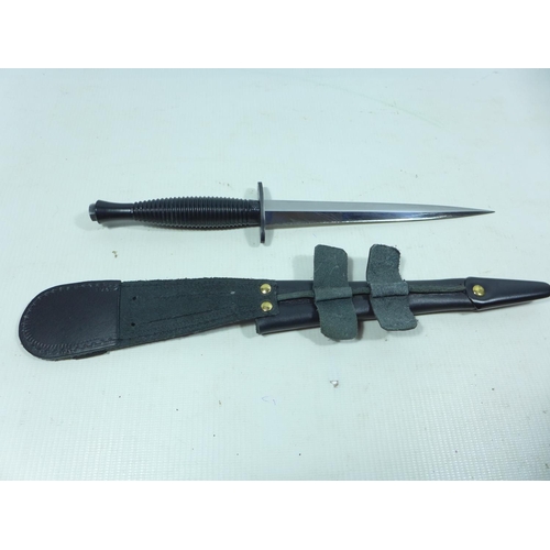 415 - A FAIRBAIRN SYKES FIGHTING KNIFE AND SCABBARD 17.5 CM BLADE, THE GUARD WITH MILITARY MARKS