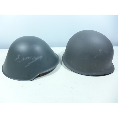 437 - TWO GREY PAINTED METAL HELMETS AND LINERS