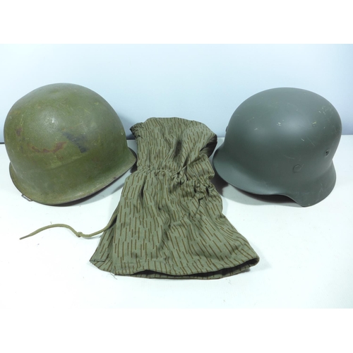 438 - A GERMAN METAL HELMET AND LINER, GREEN PAINTED METAL HELMET AND A CAMOUFLAGE HOOD