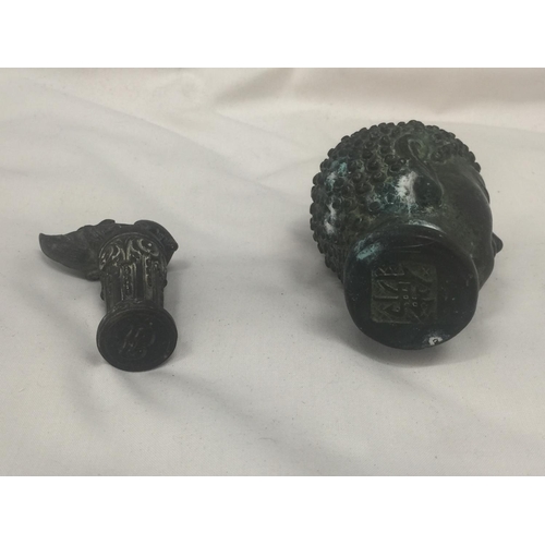 141 - TWO POSSIBLY BRONZE ORIENTAL FIGURES WITH STAMPS TO THE BASE IN THE SHAPE OF A THAI BUDDAH AND A BOA... 