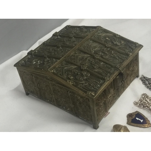 145 - A HEAVY BRASS JEWELLERY BOX EMBOSSED WITH ECCLESIASTICAL IMAGES AND VELVET LINING CONTAINING A QUANT... 