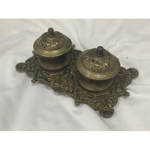 150 - A VINTAGE BRASS INKWELL WITH ORNATE DECORATION INCLUDING ONE LINER