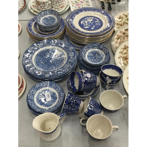 224 - A LARGE QUANTITY OF BLUE AND WHITE PLATES, BOWLS, CUPS AND SAUCERS IN 'WILLOW' AND 'LIBERTY BLUE'