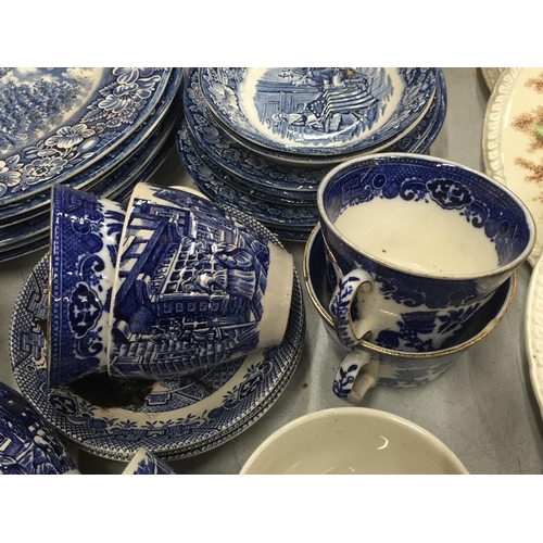 224 - A LARGE QUANTITY OF BLUE AND WHITE PLATES, BOWLS, CUPS AND SAUCERS IN 'WILLOW' AND 'LIBERTY BLUE'