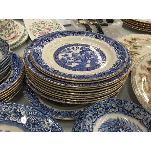 224 - A LARGE QUANTITY OF BLUE AND WHITE PLATES, BOWLS, CUPS AND SAUCERS IN 'WILLOW' AND 'LIBERTY BLUE'