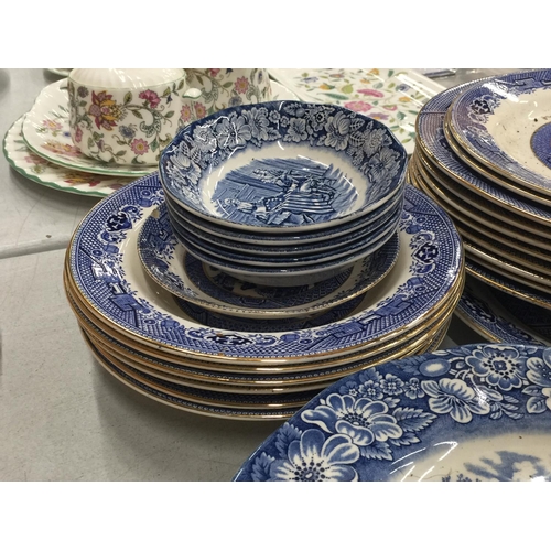 224 - A LARGE QUANTITY OF BLUE AND WHITE PLATES, BOWLS, CUPS AND SAUCERS IN 'WILLOW' AND 'LIBERTY BLUE'