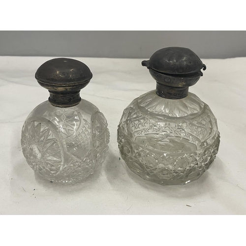 24 - TWO CUT GLASS BOTTLES WITH HALLMARKED SILVER TOPS ONE BIRMINGHAM ONE CHESTER