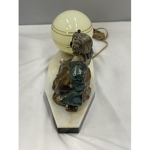 26 - AN UNUSUAL DECO LAMP WITH PIANTED BRASS LADY WITH A PEACOCK, GLOBE SHAPED SHADE ON A MARBLE BASE