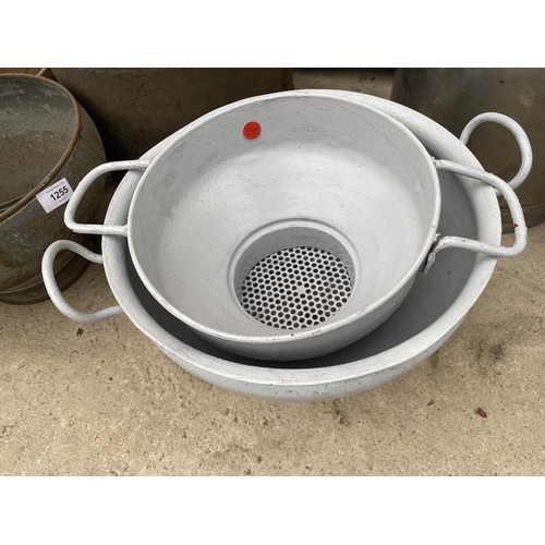 1254 - A STAINLESS STEEL MILKING BUCKET AND TWO METAL MILK CHURN SIEVES