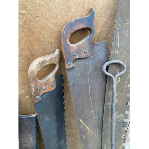 1287 - THREE VINTAGE CROSS CUT SAWS AND A VINTAGE CAST IRON DOUGH SHOVEL