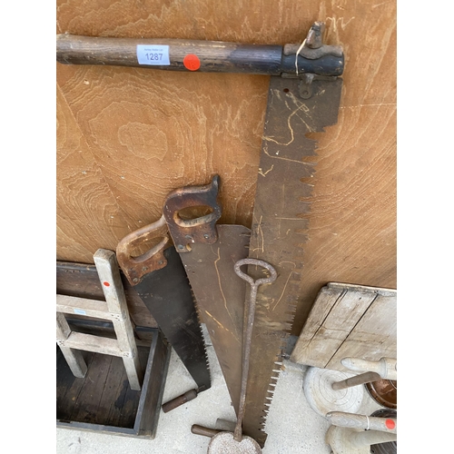 1287 - THREE VINTAGE CROSS CUT SAWS AND A VINTAGE CAST IRON DOUGH SHOVEL