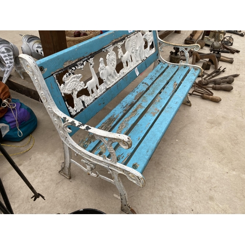 1342 - A WOODEN SLATTED CHILDREN'S BENCH WITH CAST IRON BENCH ENDS AND PLASTIC JUNGLE SCENE BACK