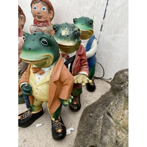 1379 - A RECONSTITTUED STONE DOG GARDEN FIGURE AND THREE RESIN TOADS