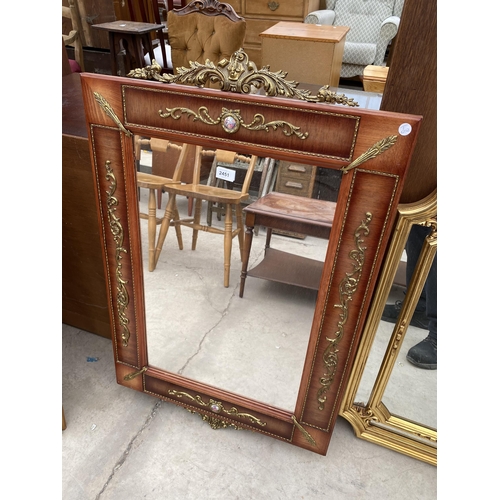 2451 - A MODERN REGENCY STYLE WALL MIRROR WITH APPLIED GILT METAL DECORATION AND TWO SMALL PORCELAIN PANELS... 