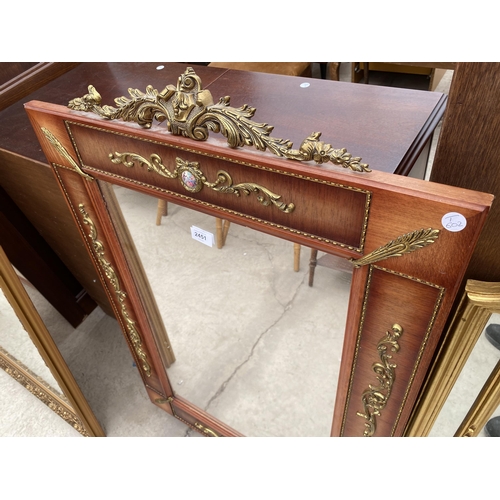 2451 - A MODERN REGENCY STYLE WALL MIRROR WITH APPLIED GILT METAL DECORATION AND TWO SMALL PORCELAIN PANELS... 