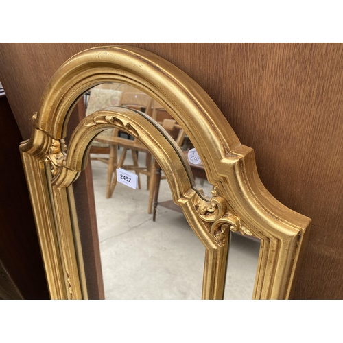 2452 - A MODERN GILT FRAMED WALL MIRROR, 3420