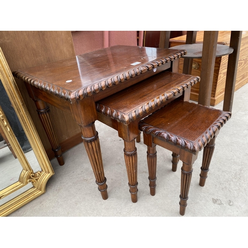 2453 - A NEST OF THREE HARDWOOD TABLES WITH ROPE EDGES ON TURNED AND FLUTED LEGS