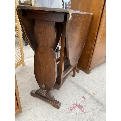 2461 - AN OAK OVAL GATELEG TABLE