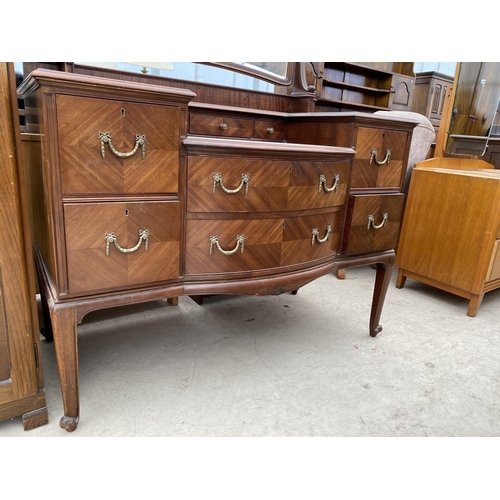 2463 - AN EDWARDIAN MAHOGANY BOWFRONTED DRESSING TABLE ENCLOSING FOUR SHORT, TWO LONG AND THREE JEWELLED DR... 