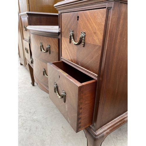 2463 - AN EDWARDIAN MAHOGANY BOWFRONTED DRESSING TABLE ENCLOSING FOUR SHORT, TWO LONG AND THREE JEWELLED DR... 