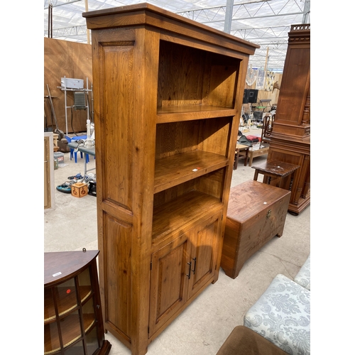 2484 - A MODERN OAK OPEN DISPLAY UNIT WITH THREE TIERS, HAVING TWO PANELLED DOORS TO THE ASE, WITH METALWAR... 