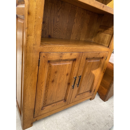 2484 - A MODERN OAK OPEN DISPLAY UNIT WITH THREE TIERS, HAVING TWO PANELLED DOORS TO THE ASE, WITH METALWAR... 