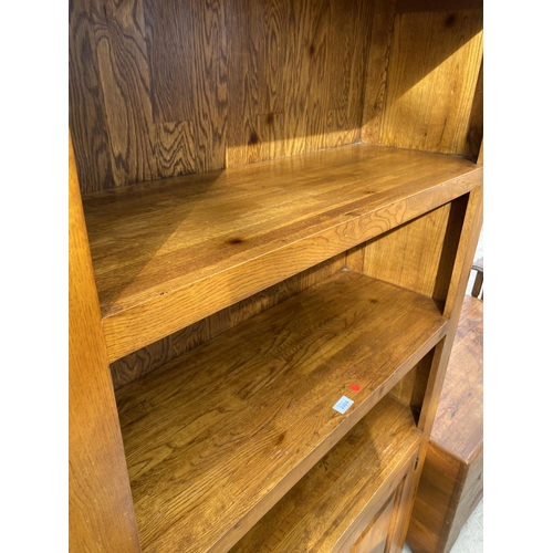 2484 - A MODERN OAK OPEN DISPLAY UNIT WITH THREE TIERS, HAVING TWO PANELLED DOORS TO THE ASE, WITH METALWAR... 