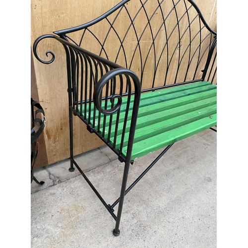 1215 - A WROUGHT IRON TWO SEATER GARDEN BENCH WITH WOODEN SLATTED SEAT (L:134CM)