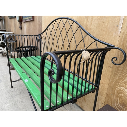 1215 - A WROUGHT IRON TWO SEATER GARDEN BENCH WITH WOODEN SLATTED SEAT (L:134CM)