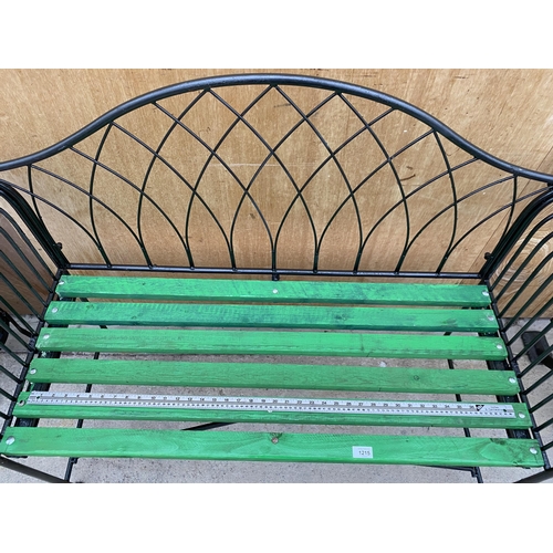 1215 - A WROUGHT IRON TWO SEATER GARDEN BENCH WITH WOODEN SLATTED SEAT (L:134CM)